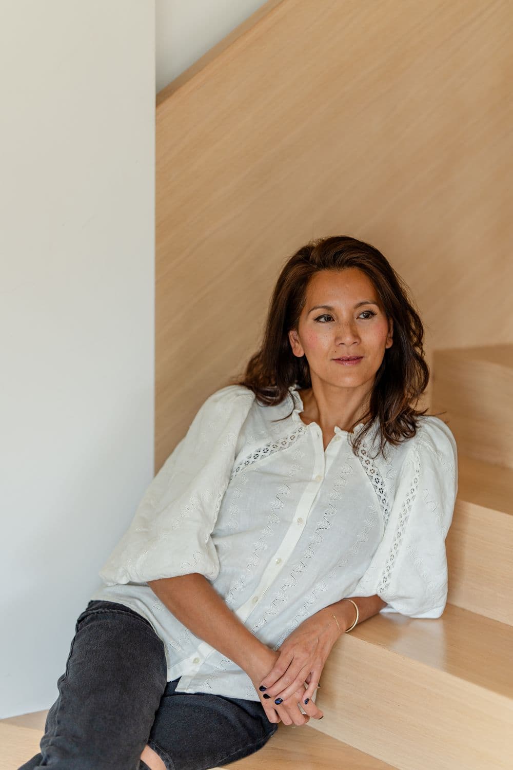 Marie-Ange sitting on wooden stairs
