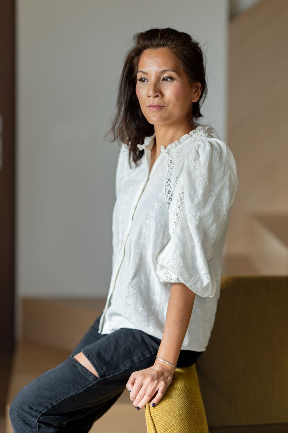 Marie-Ange leaning on a yellow chair